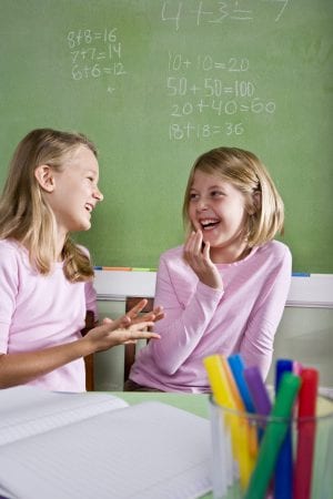 Two elementary school girls, talking and laughing in math class | Math Solutions, Classroom Lessons, Classroom Discussions: Using Math Talk in Elementary Classrooms