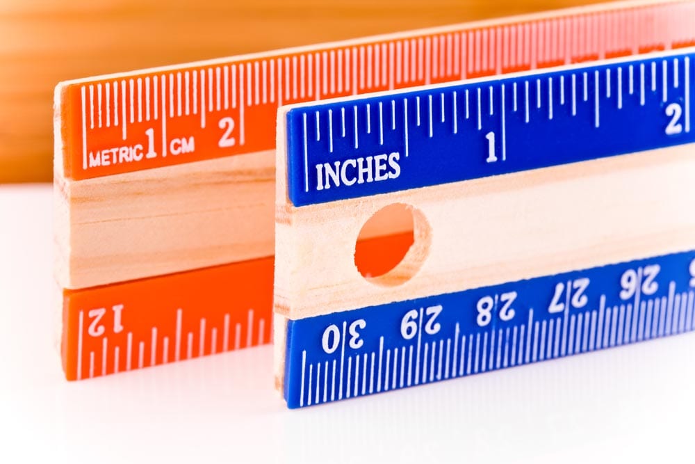 Units of measurement for length: inches (the English system) and centimeters (the Metric system). Rulers are aligned so the left edge of the ruler in the foreground marks the conversion of one inch into centimeters (roughly 2.5cm).Shot at f/13. Most but not all imperfections cloned out of rulers.