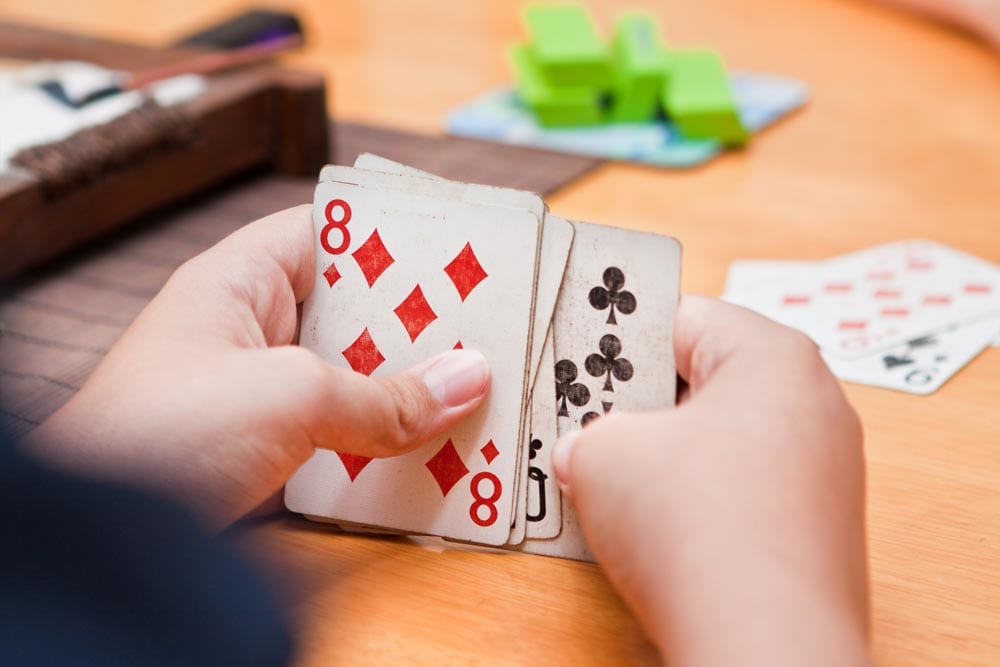 Kids Playing Cards At Table