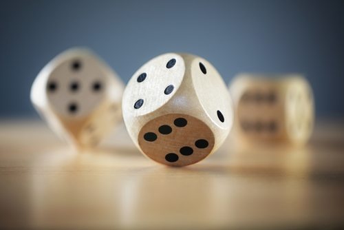 wooden dice rolling on a table