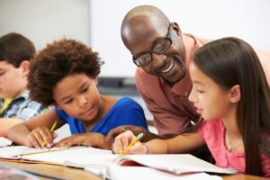 young math students with male teacher | Scaffold learning provides a framework for achievement.