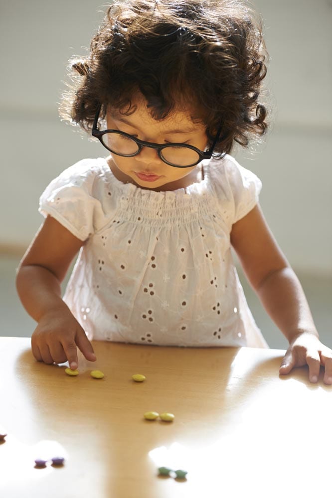 A little girl counting her candy